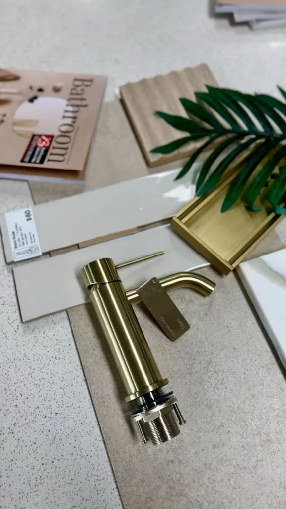 Coastal moodboard showcasing oak cabinetry and gold accents for a serene atmosphere.