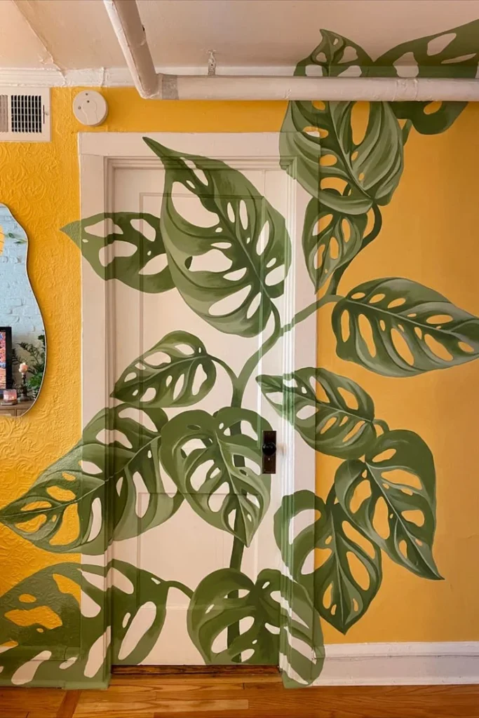 Living room featuring a vibrant Monstera mural that enhances the decor