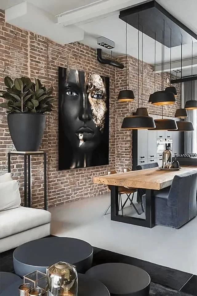 Modern loft living room with striking black brick accent wall and contemporary furnishings.